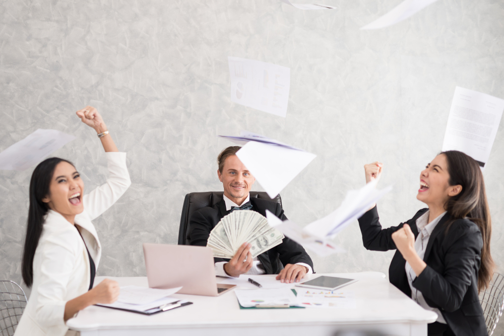 Cheerful young people celebrating success