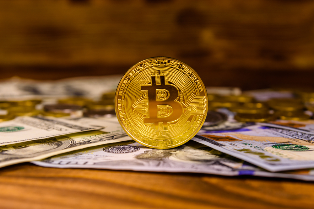 Bitcoins and hundred dollar bills