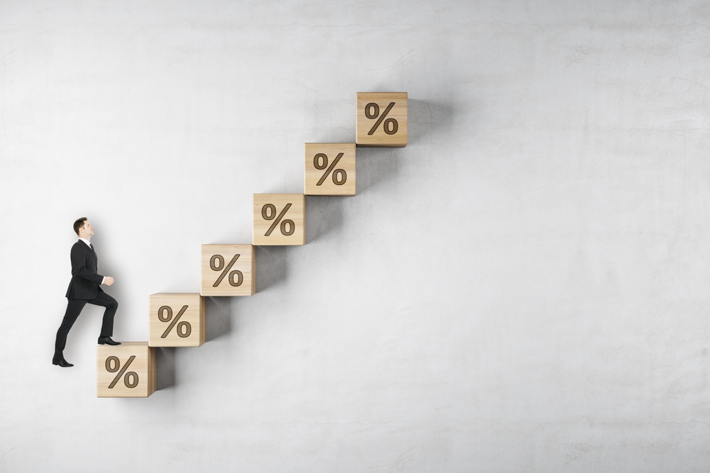 Businessman walks up steps toward financial growth