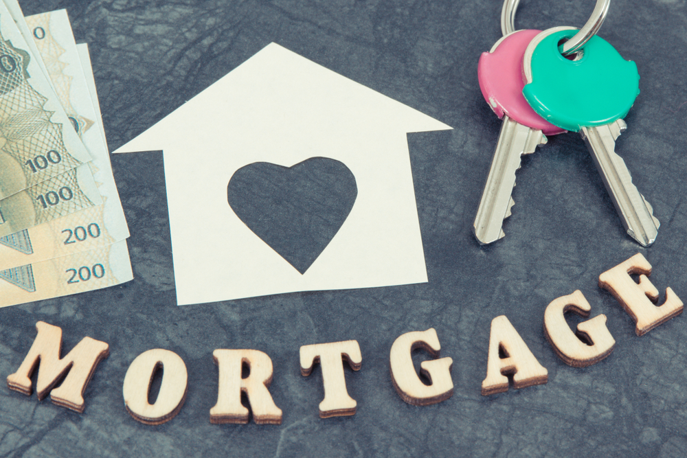 House keys and home shape with currencies