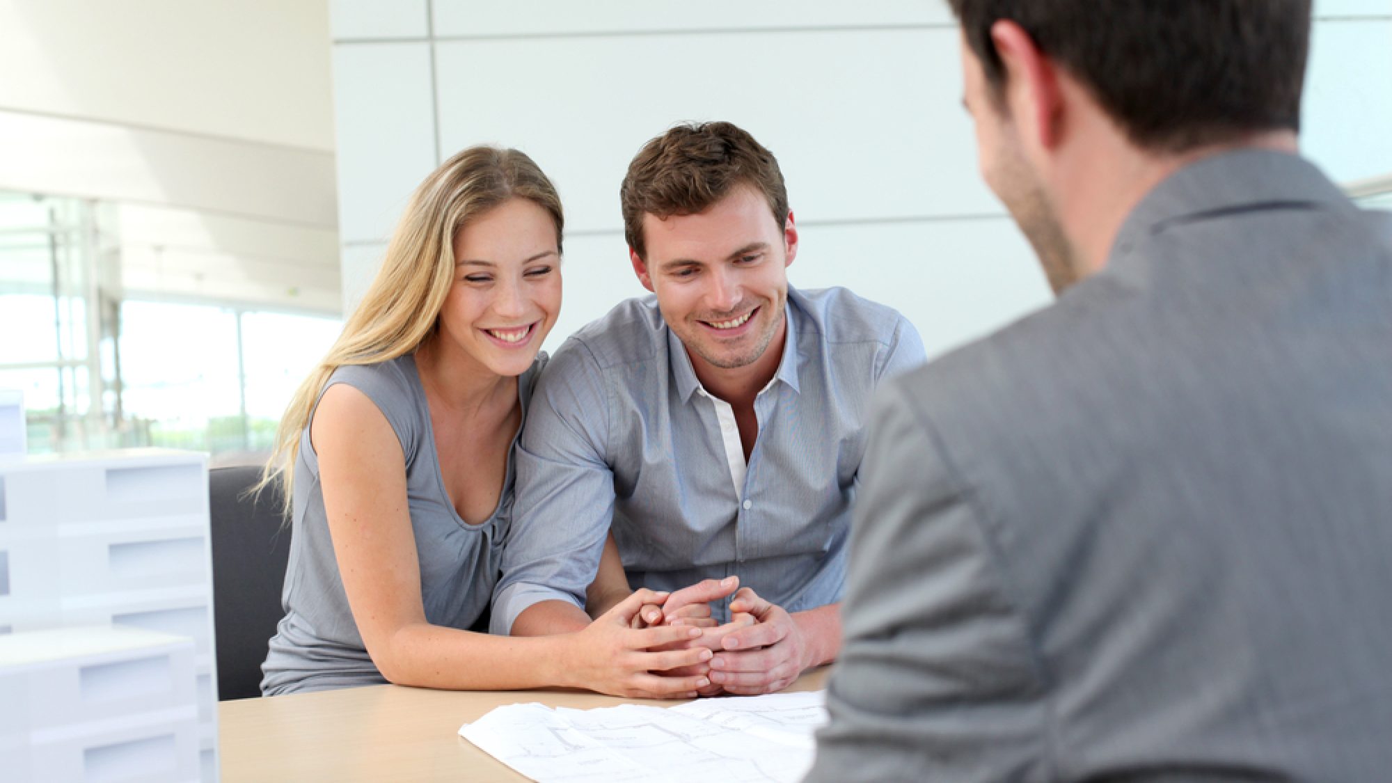 Couple,In,Real-estate,Agency,Talking,To,Construction,Planner