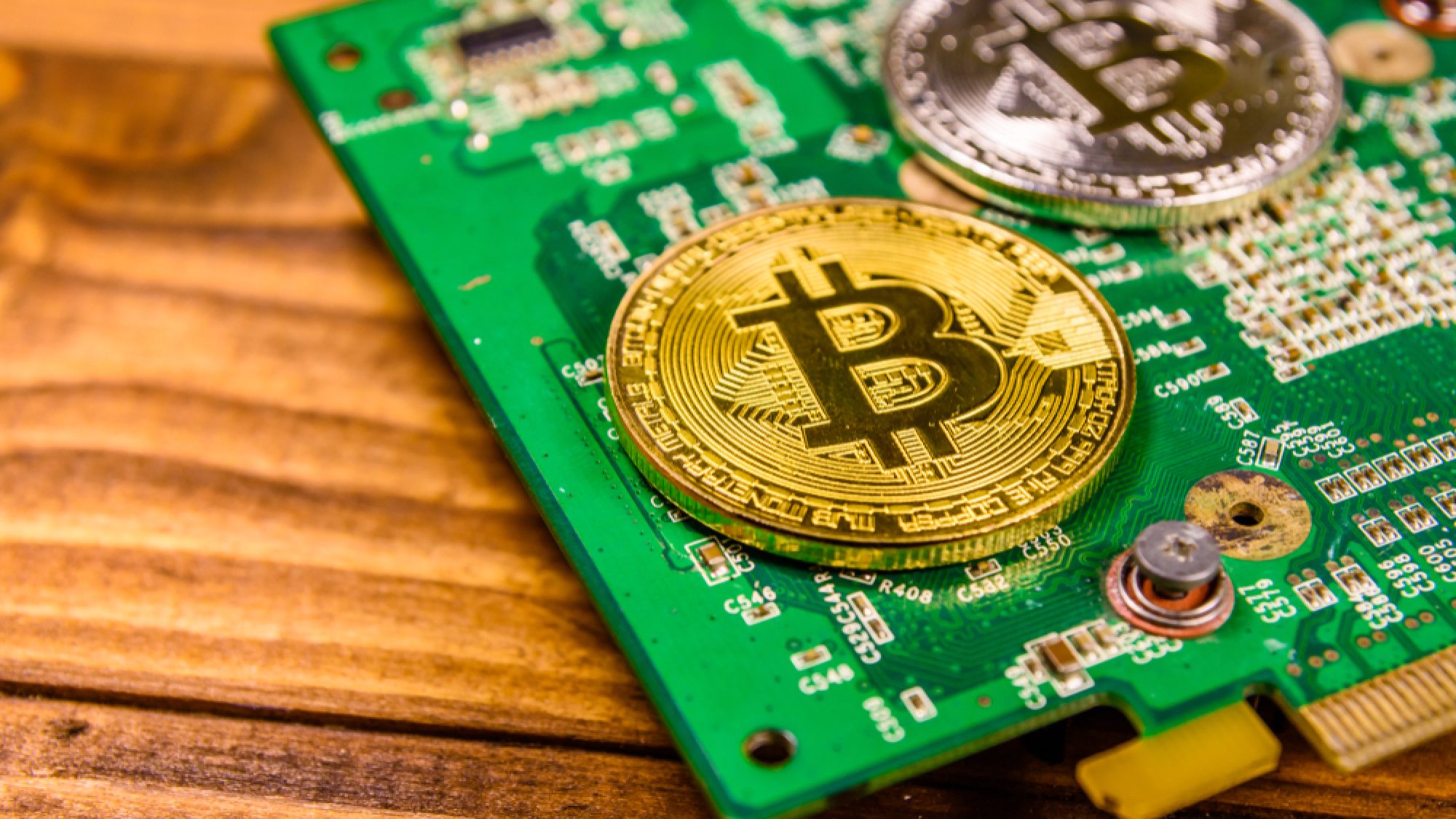 Bitcoins,And,Circuit,Board,On,Rustic,Wooden,Table