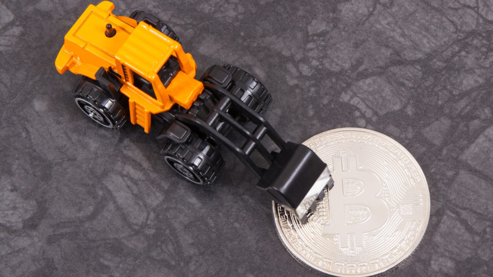 Silver,Bitcoin,As,Virtual,Money,And,Miniature,Excavator,,Concept,Of