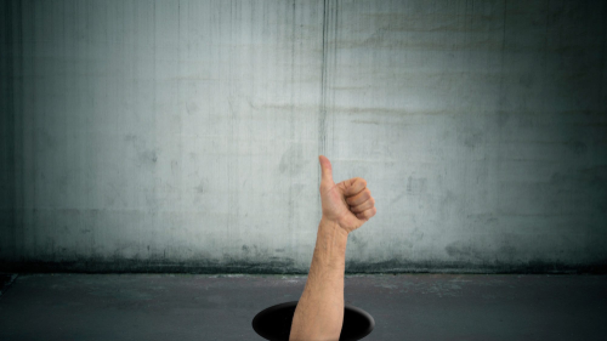 Hand,With,Okay,Signal,Dropping,Into,The,Hole