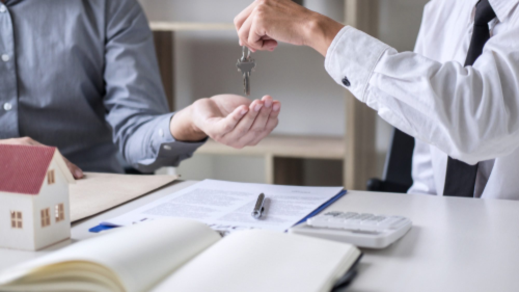 Real,Estate,Sales,Manager,Giving,Keys,To,Customer,After,Signing