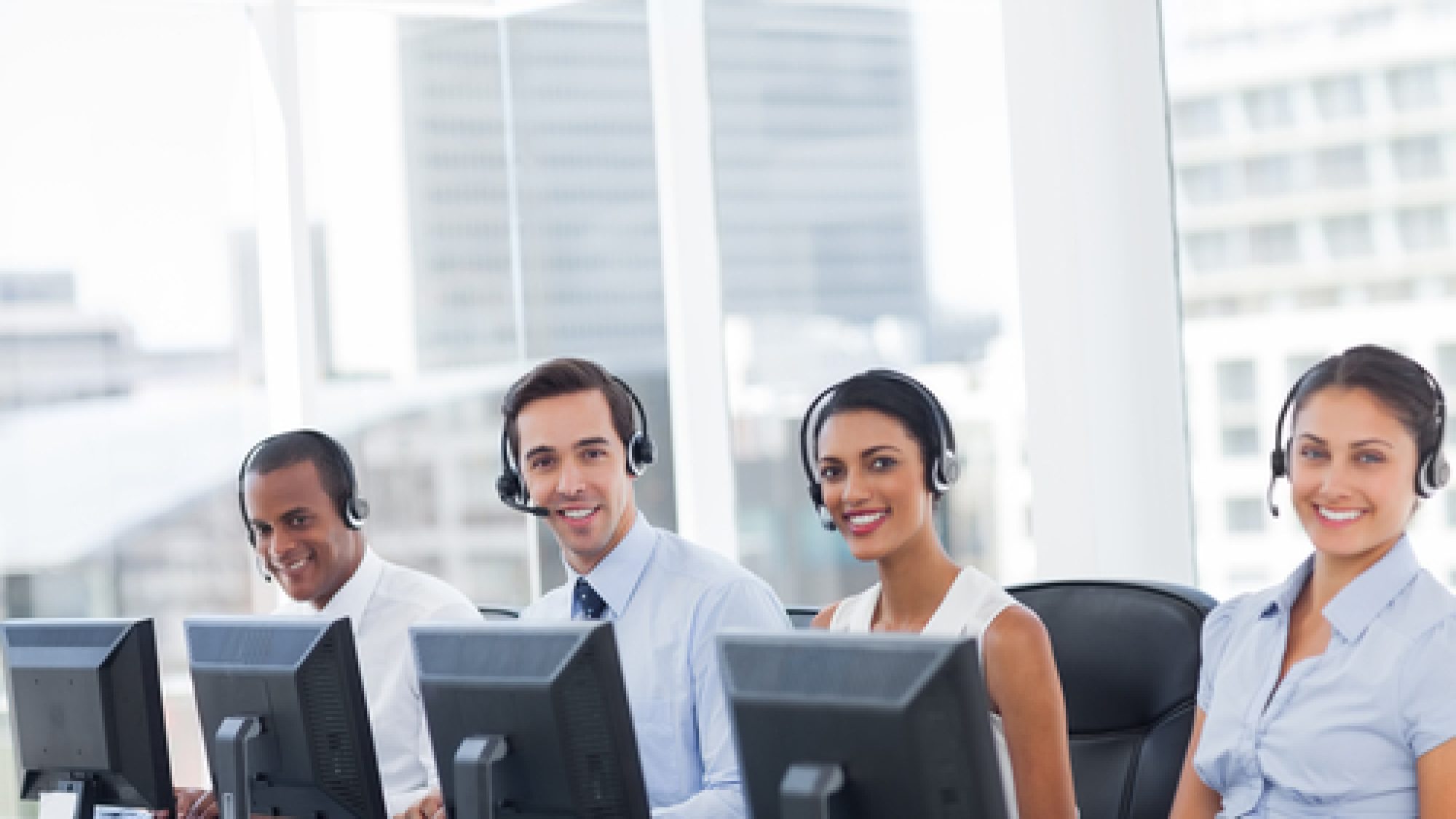 Line,Of,Call,Centre,Employees,Smiling,And,Working,On,Computers