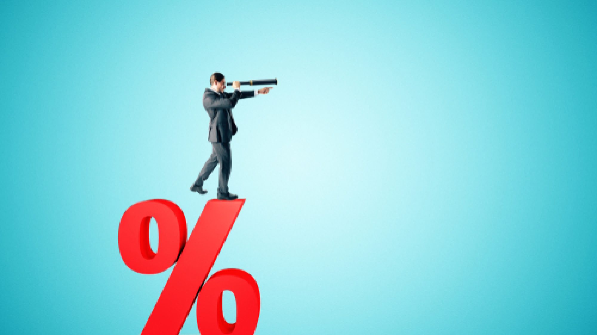 Side,View,Of,Young,Businessman,Standing,On,Red,Percent,Sign