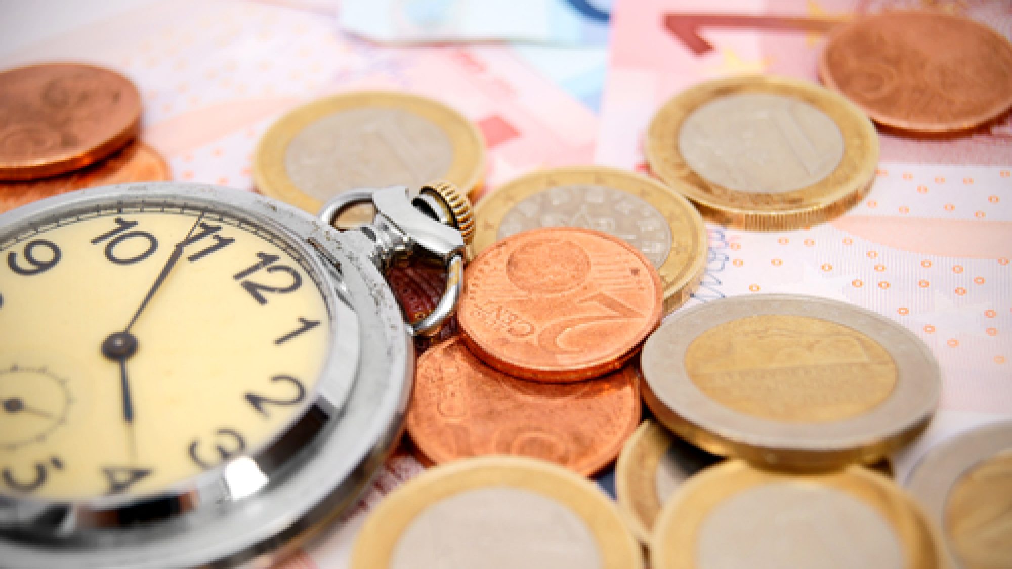 Watch,And,Coins,On,The,Euro,Banknotes.