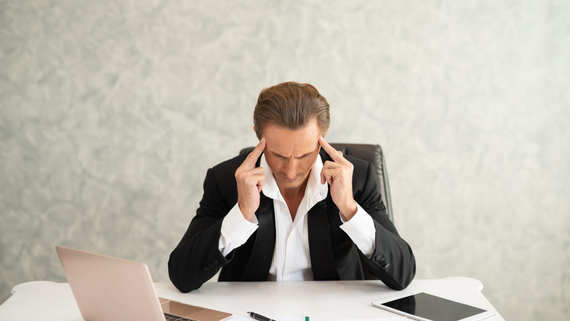 Businessman,In,A,Black,Suit,With,Anxiety,In,The,Office.