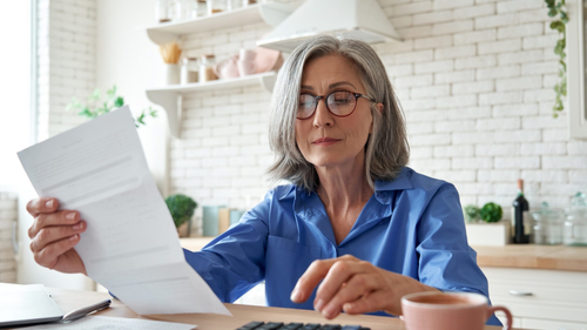Senior,Mature,Business,Woman,Holding,Paper,Bill,Using,Calculator,,Old