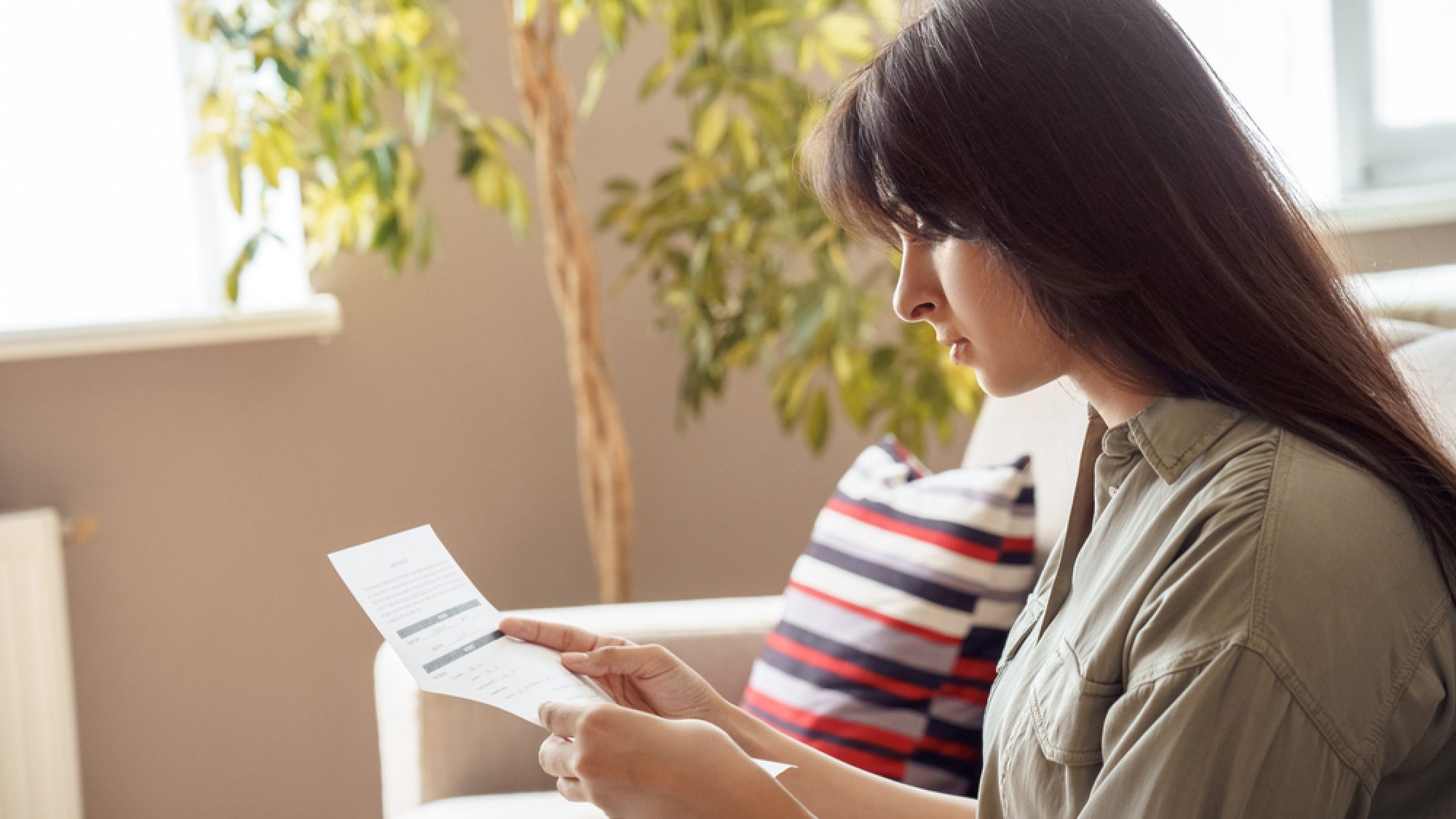 Young,Adult,Indian,Woman,Holding,Invoice,,Reading,Bill,,Reviewing,Paycheck,
