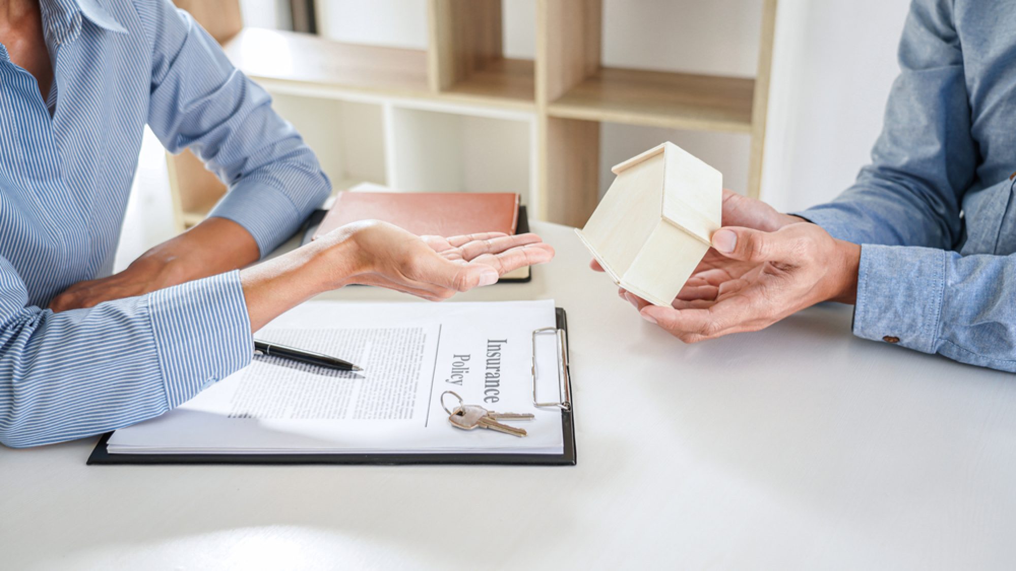 Real,Estate,Sales,Manager,Giving,Keys,And,House,Model,To