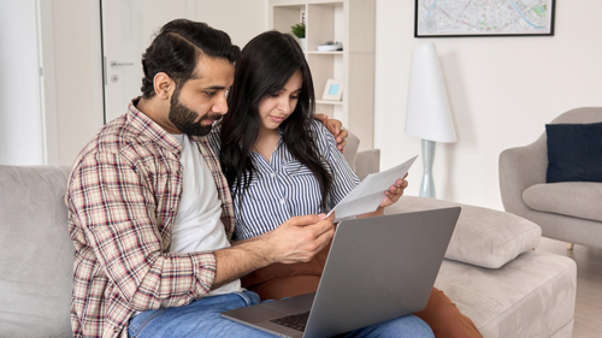 Young,Indian,Couple,Reading,Paper,Bills,Paying,Loan,Bank,Debt