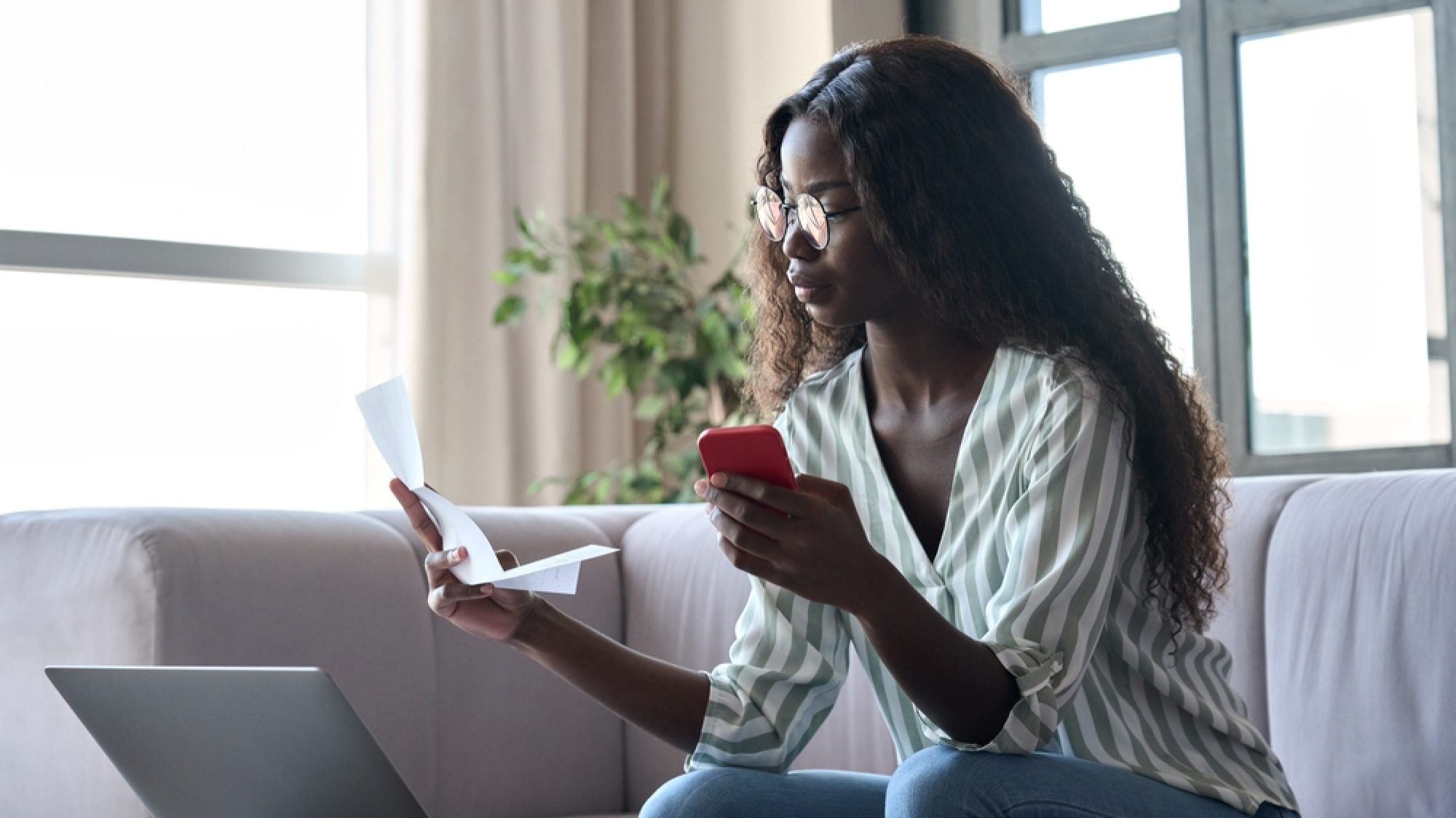 Serious,Young,Black,African,Woman,Holding,Paper,Document,Calculating,Rent