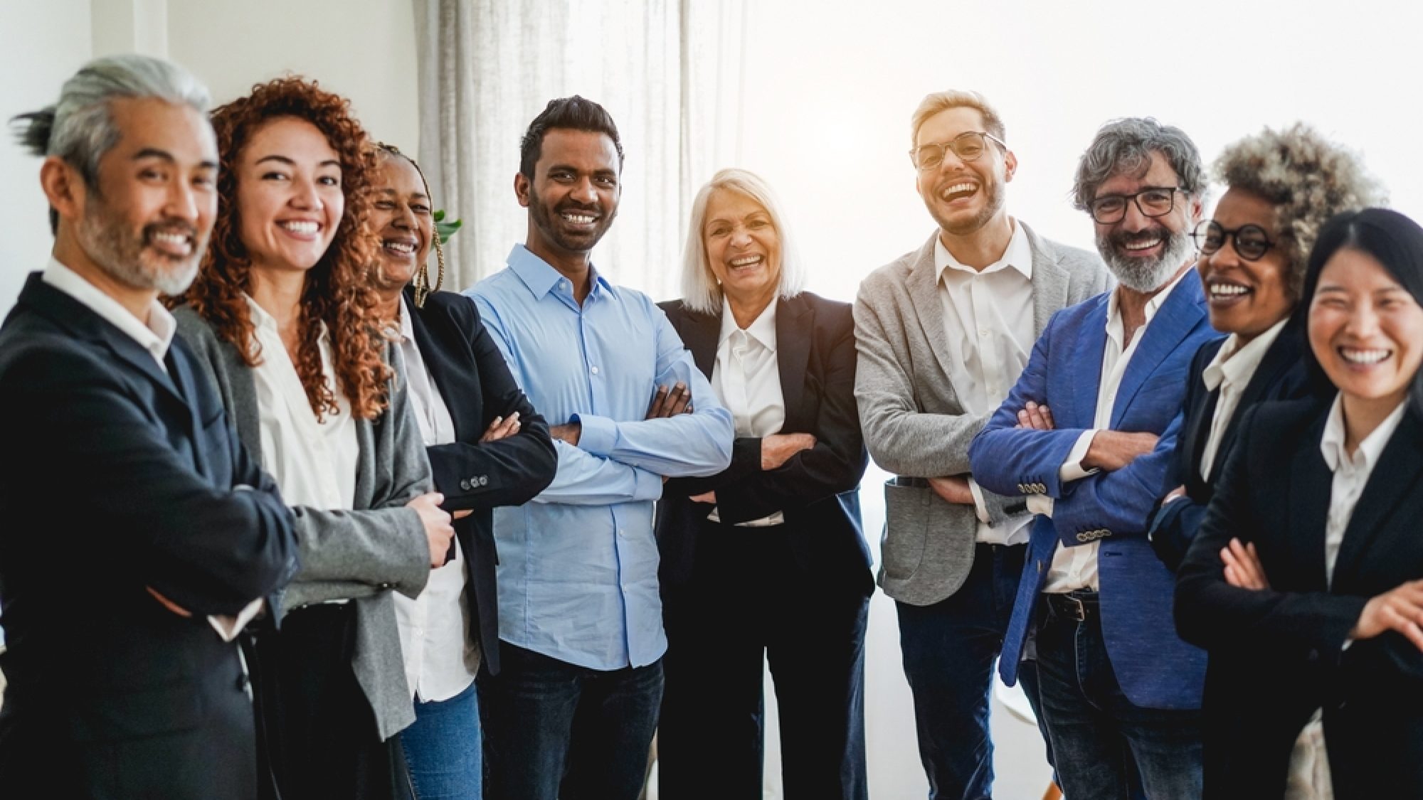 Multiracial,Business,People,Looking,At,Camera,Inside,Bank,Office,