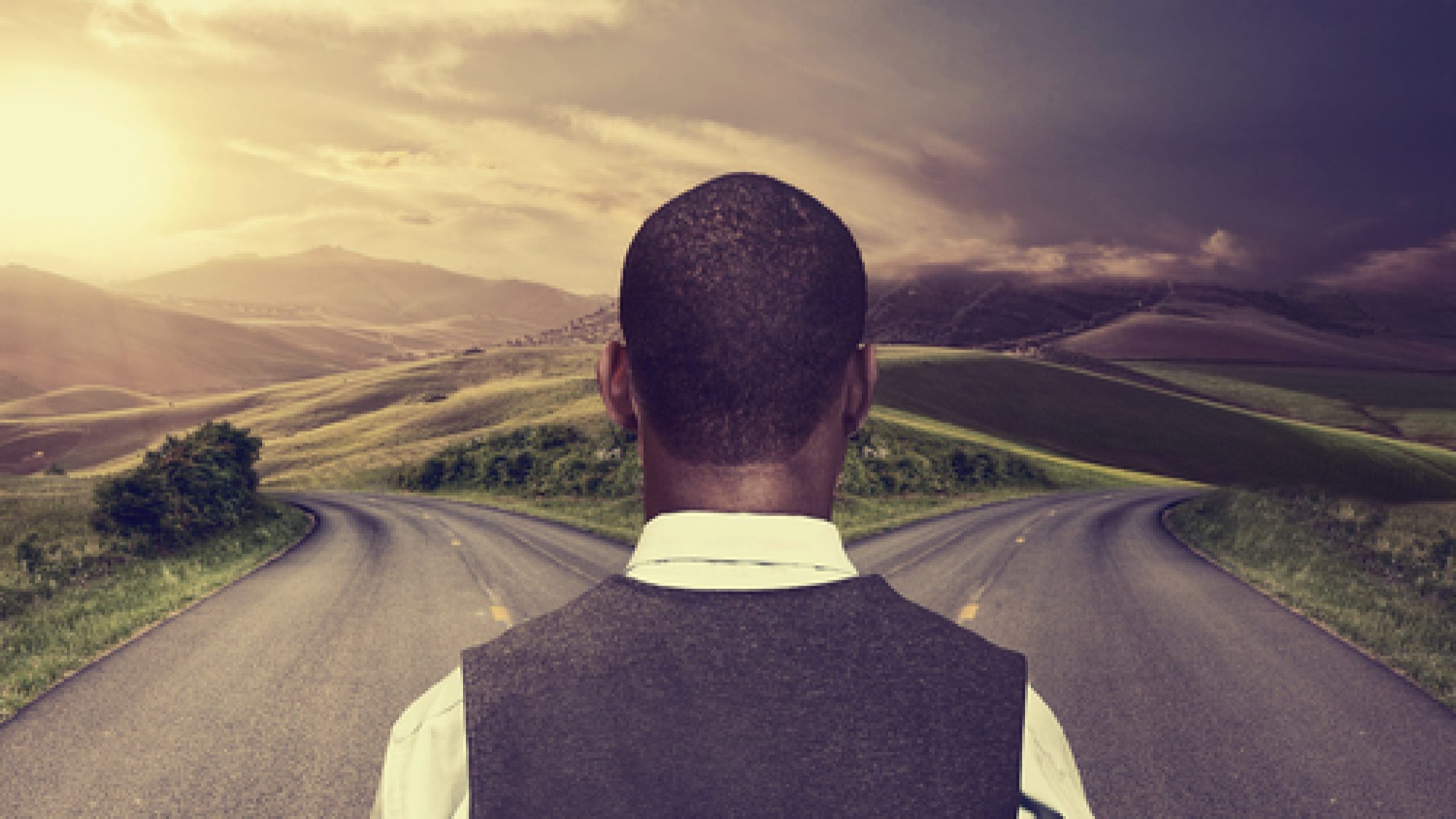 Businessman,In,Front,Of,Two,Roads,Hoping,For,Best,Taking