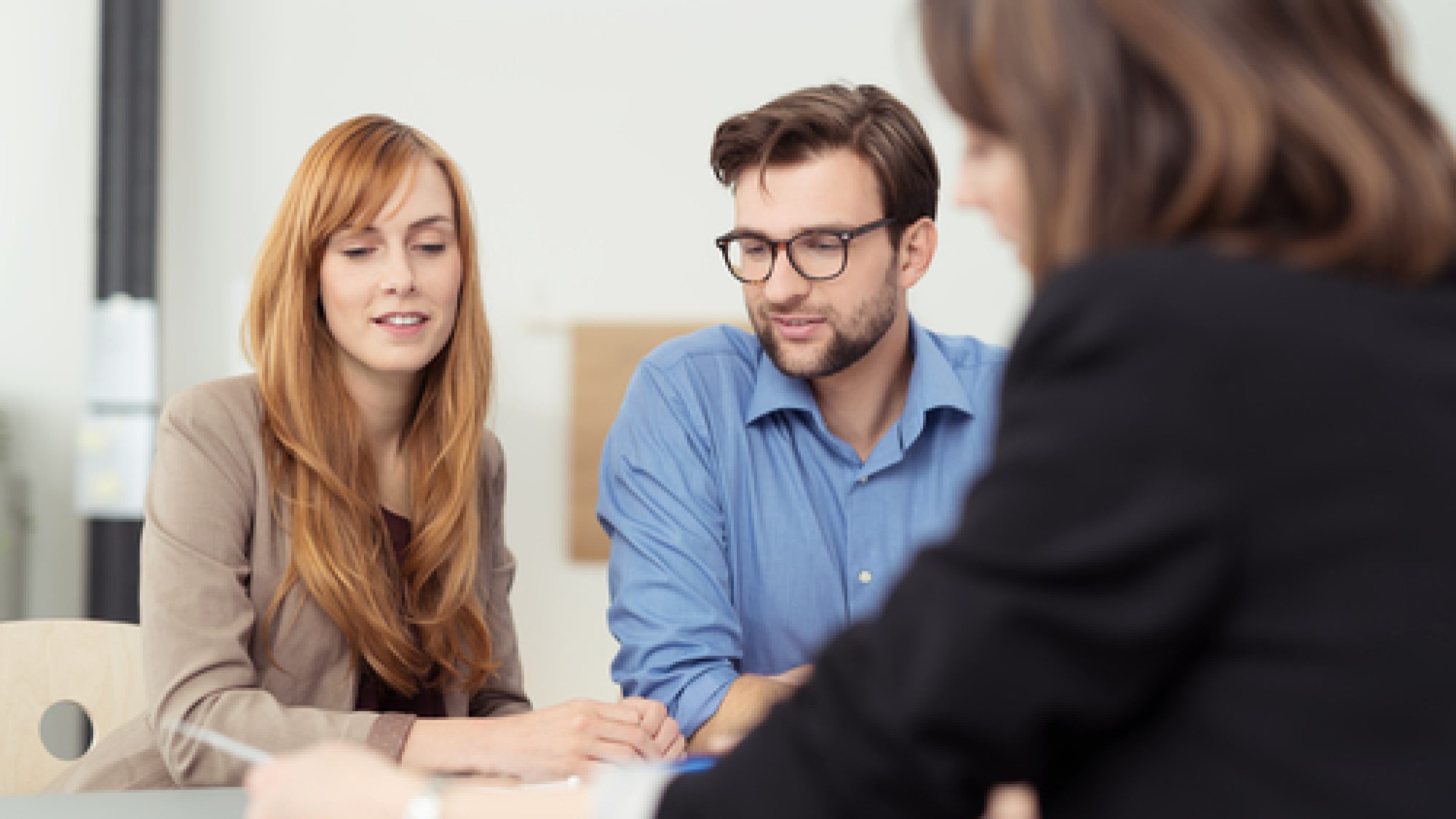 Broker,Making,A,Presentation,To,A,Young,Couple,Showing,Them