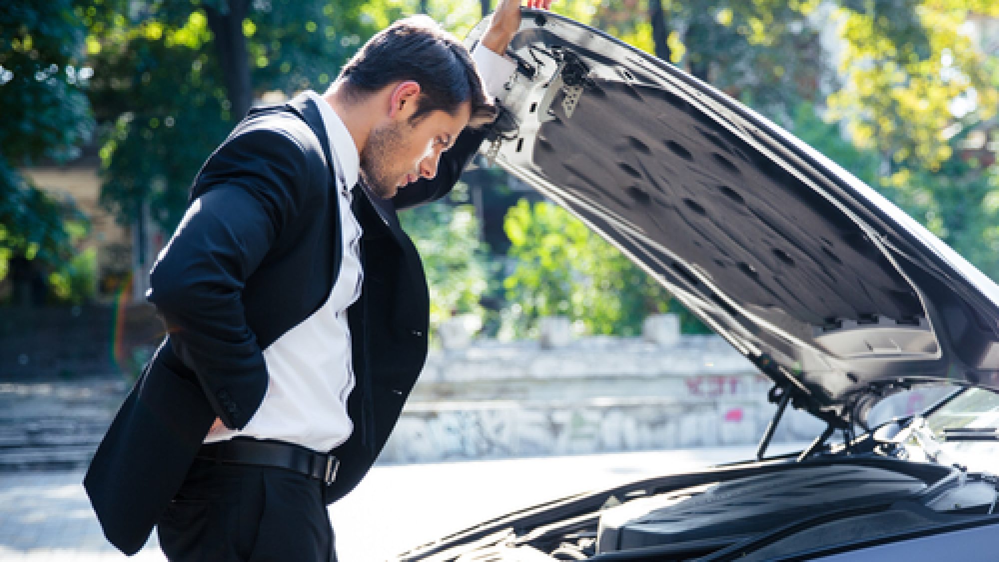 Man,Standing,Near,Broken,Car,With,Open,Hood