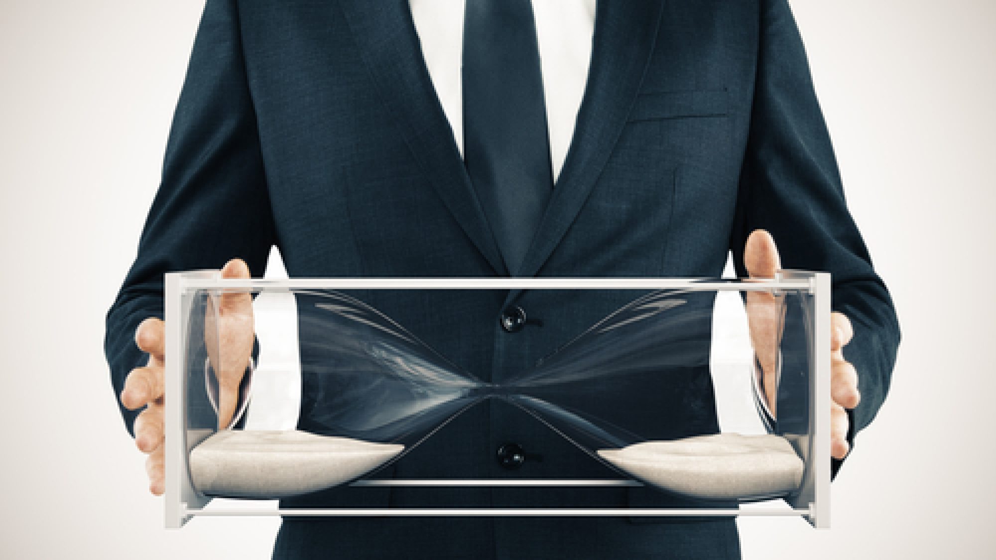 Businessman,With,Sandglass,In,The,Hands,,Frozen,Time,Concept