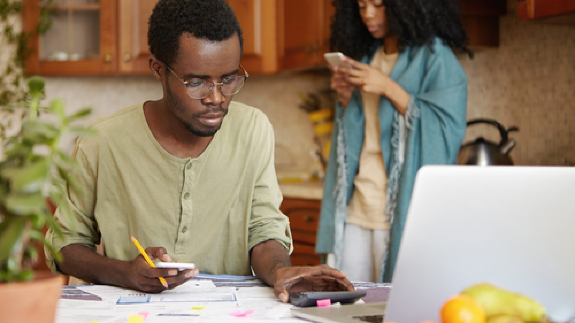 Serious,Young,Dark-skinned,Male,In,Spectacles,Using,Cell,Phone,And